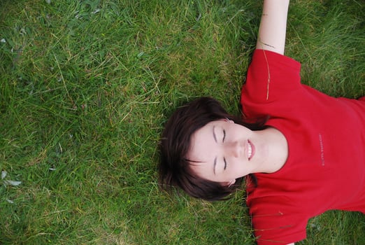 woman laying in grass photo