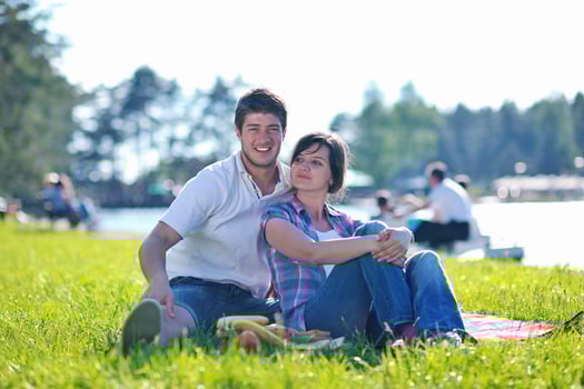 happy young couple having a picnic outdoor photo