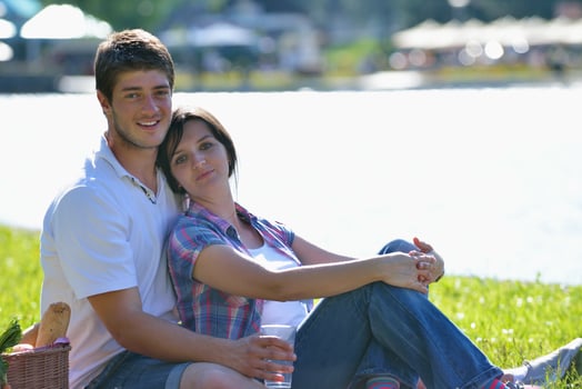 happy young couple having a picnic outdoor photo