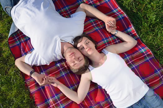 happy young couple having a picnic outdoor photo
