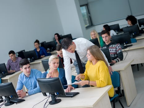 students with teacher  in computer lab classrom photo