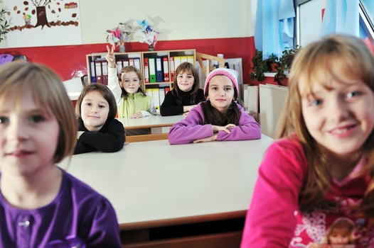 happy kids with  teacher in  school classroom photo
