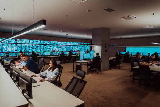Group of Security data center operators working in a CCTV monitoring room looking on multiple monitors Officers Monitoring Multiple Screens for Suspicious Activities Team working on the System Contr photo