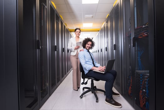 Team of young technicians working together on servers photo
