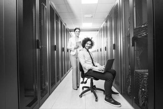 Team of young technicians working together on servers photo
