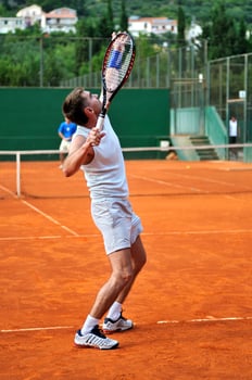 Man plays tennis outdoors photo
