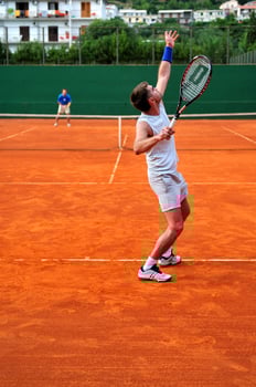 Man plays tennis outdoors photo