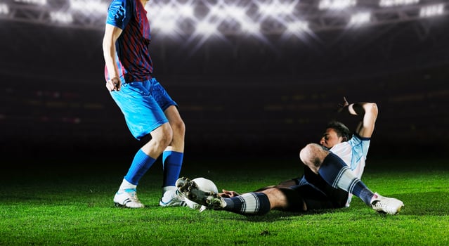 football players in competition for the ball photo