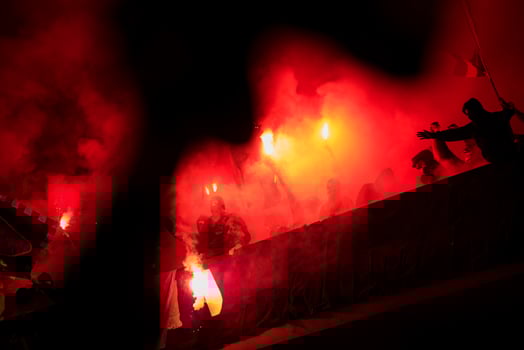 football hooligans with mask holding torches in fire photo
