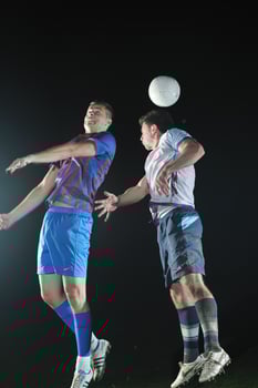 football players in competition for the ball photo