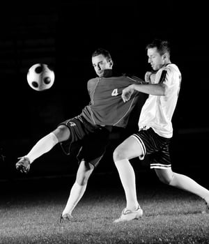 football players in action for the ball photo