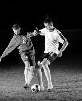 football players in action for the ball photo