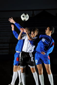 football players in action for the ball photo