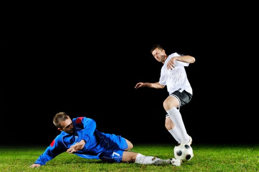 football players in action for the ball photo
