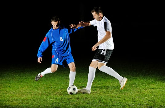 football players in action for the ball photo