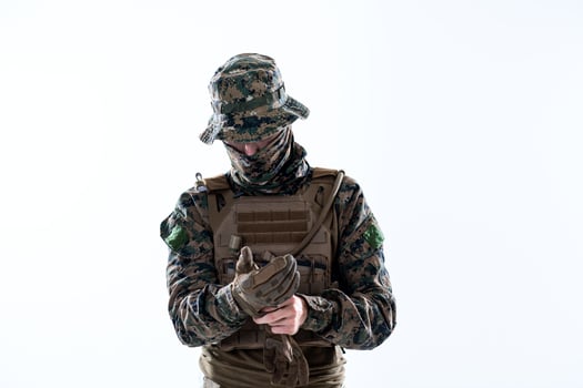 closeup of soldier hands putting protective battle gloves photo