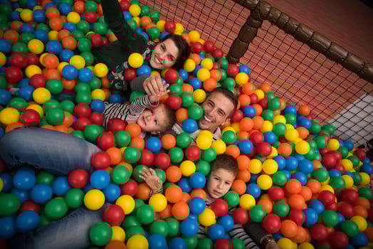 young parents with kids in a children's playroom photo