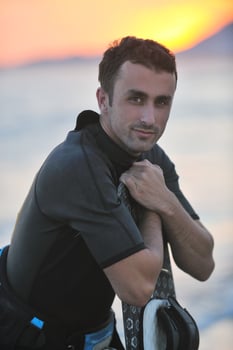 Portrait of a young  kitsurf  man at beach on sunset photo