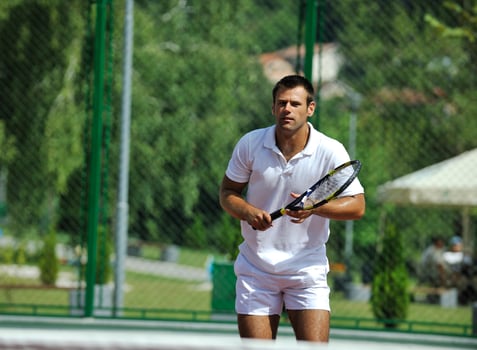 young man play tennis outdoor photo