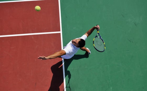young man play tennis outdoor photo