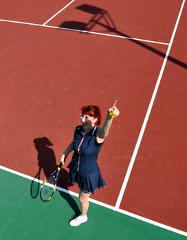 young woman play tennis game outdoor photo