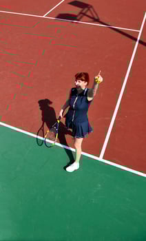 young woman play tennis game outdoor photo