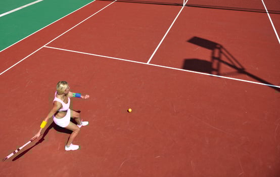 young woman play tennis game outdoor photo