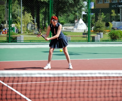 young woman play tennis game outdoor photo