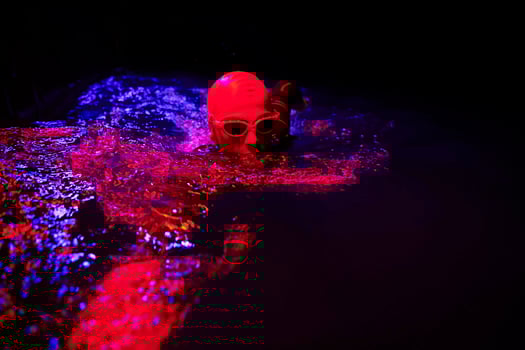 real triathlon athlete swimming in dark night photo