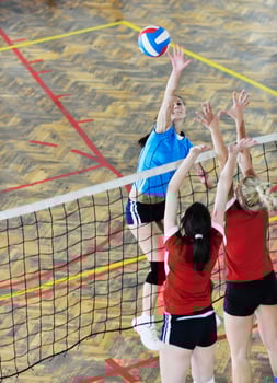 girls playing volleyball indoor game photo