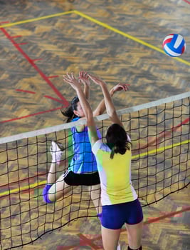 girls playing volleyball indoor game photo