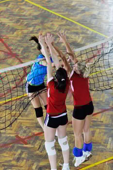 girls playing volleyball indoor game photo