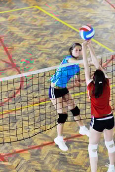 girls playing volleyball indoor game photo
