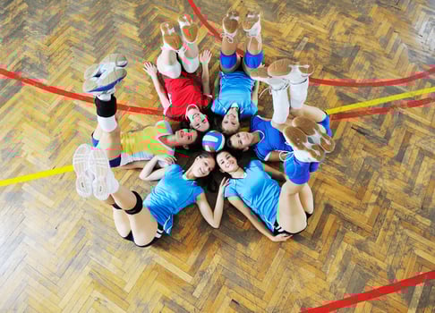 girls playing volleyball indoor game photo
