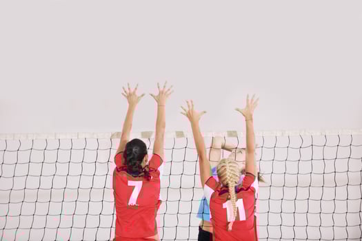 girls playing volleyball indoor game photo