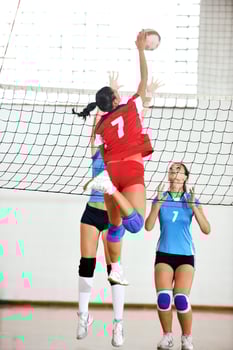 girls playing volleyball indoor game photo
