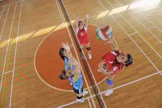 girls playing volleyball indoor game photo