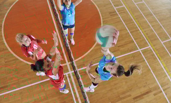 girls playing volleyball indoor game photo