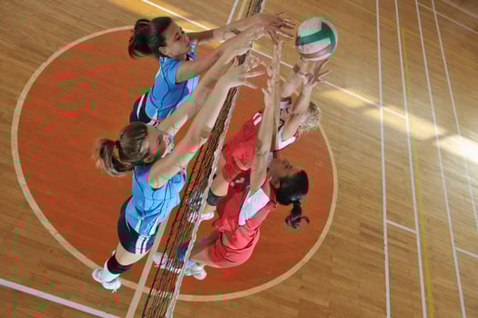 girls playing volleyball indoor game photo