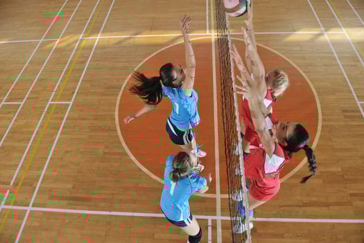 girls playing volleyball indoor game photo