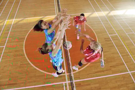 girls playing volleyball indoor game photo