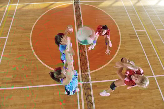 girls playing volleyball indoor game photo