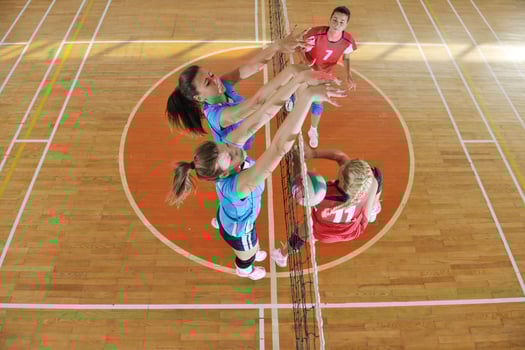 girls playing volleyball indoor game photo