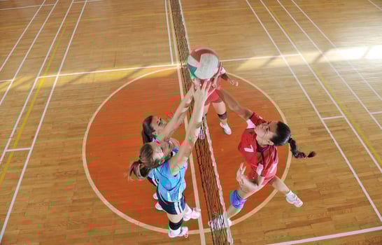 girls playing volleyball indoor game photo