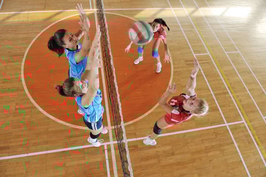 girls playing volleyball indoor game photo