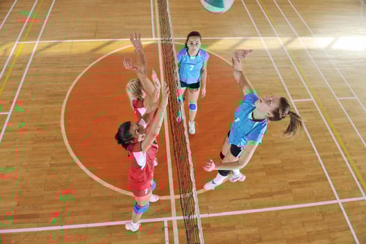 girls playing volleyball indoor game photo