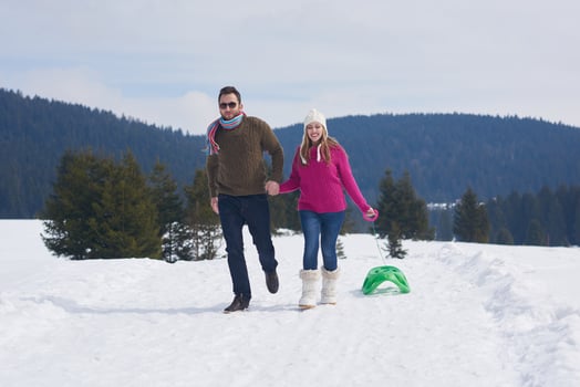 happy young couple having fun on fresh show on winter vacation photo
