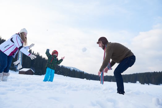 happy family playing together in snow at winter photo