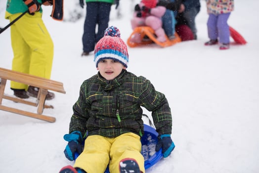 children group  having fun and play together in fresh snow photo