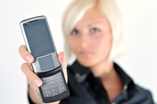 portrait of young blonde business woman holding new modern cellp photo